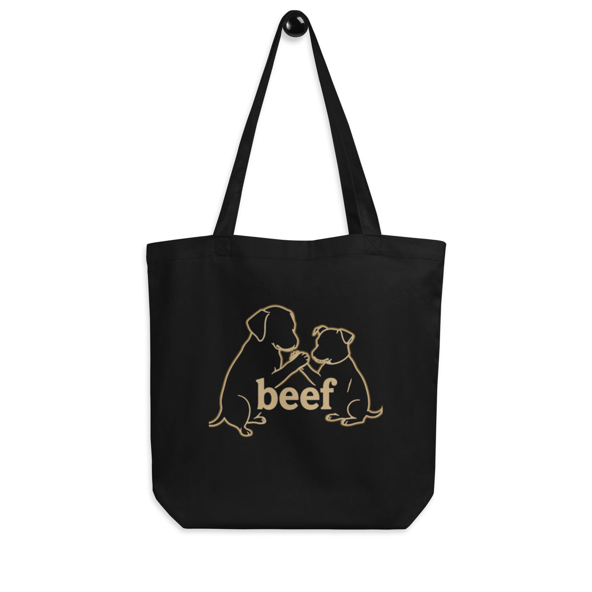 Black 'beef showdown' organic canvas tote bag hanging on a hook, two dogs arm wrestling, cozy bluesky