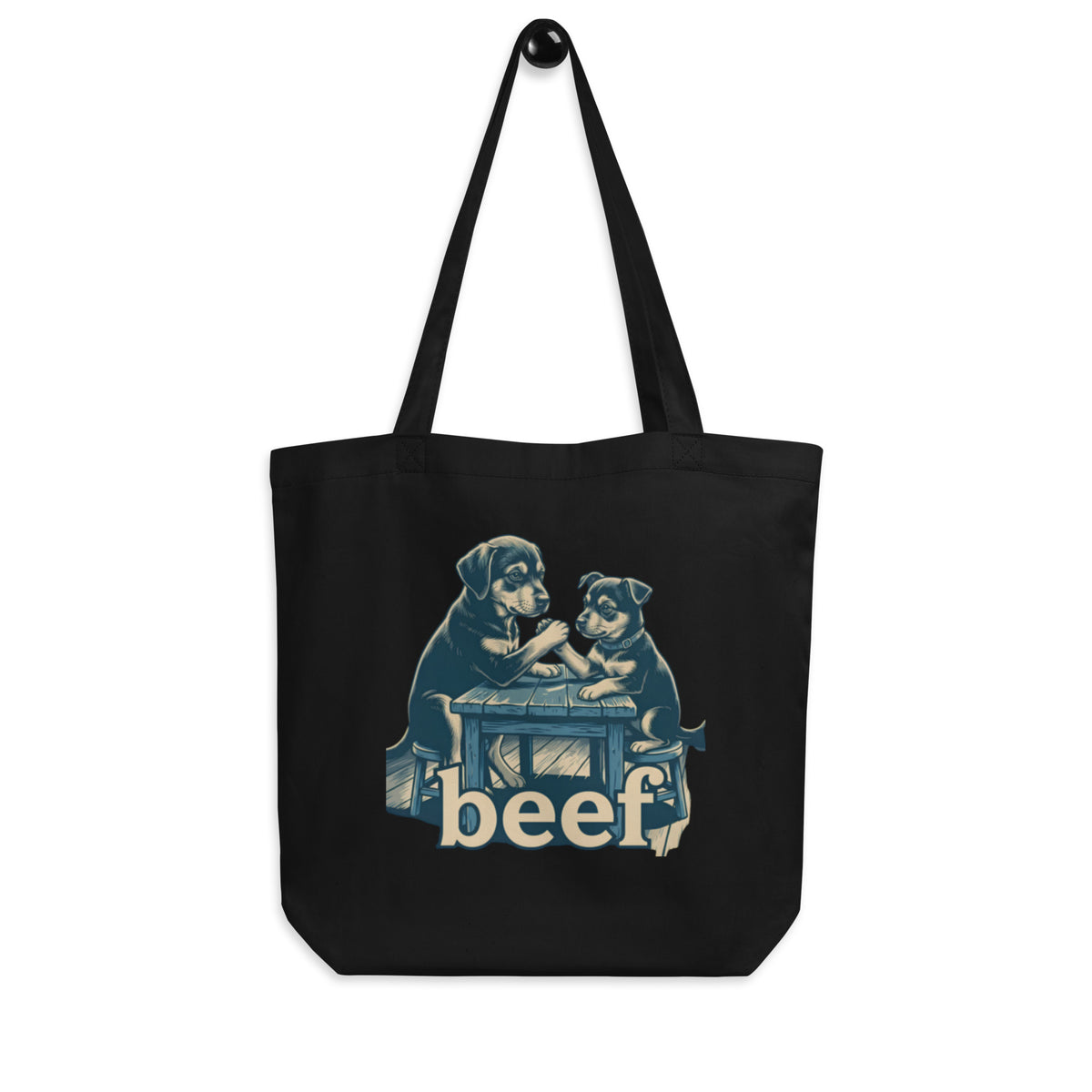 Black 'beef' organic canvas tote bag hanging on a hook, two dogs arm wrestling at a table, cozy bluesky