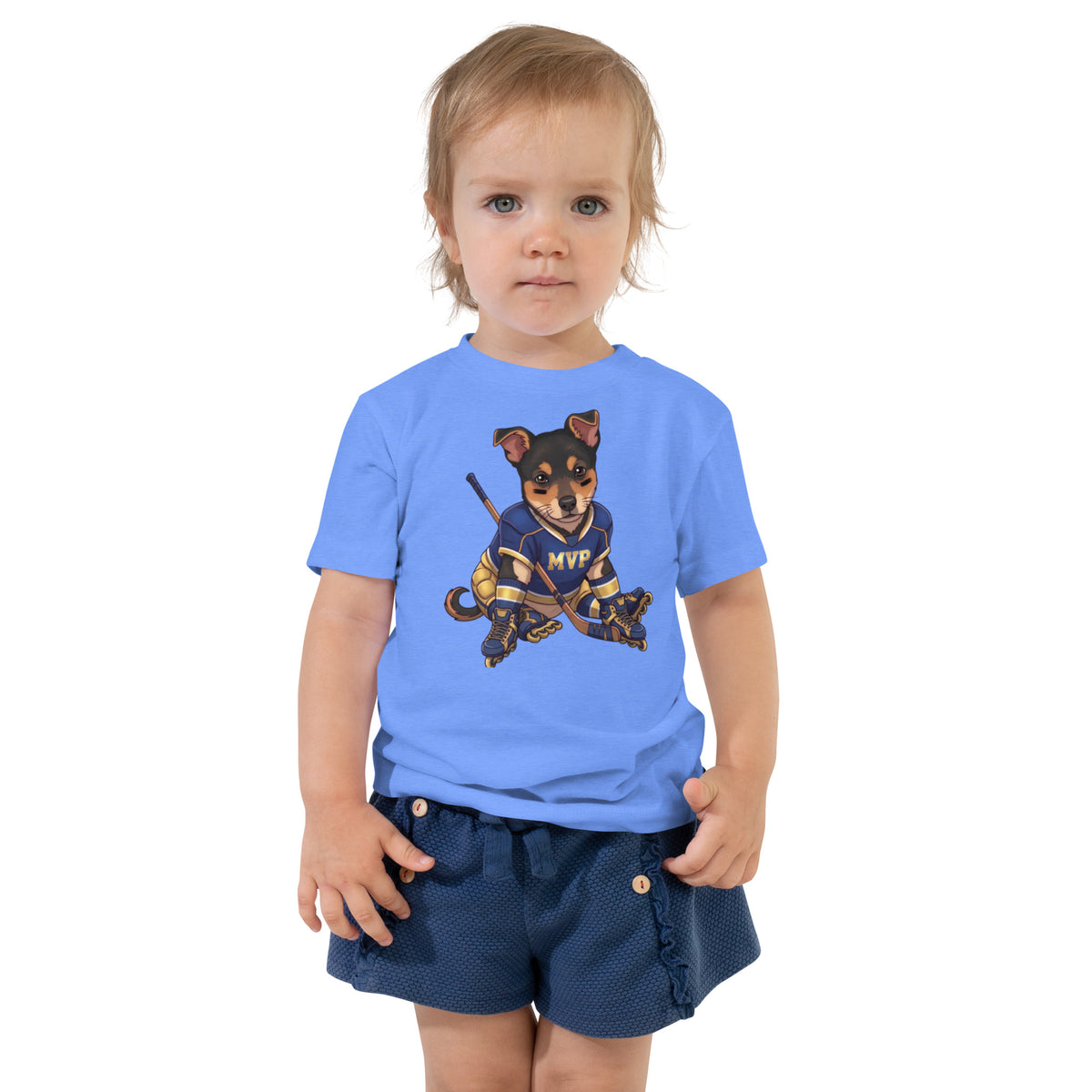 Toddler girl wearing a heather columbia blue 'hockey MVP' toddler t-shirt, dog in an MVP hockey jersey with a stick