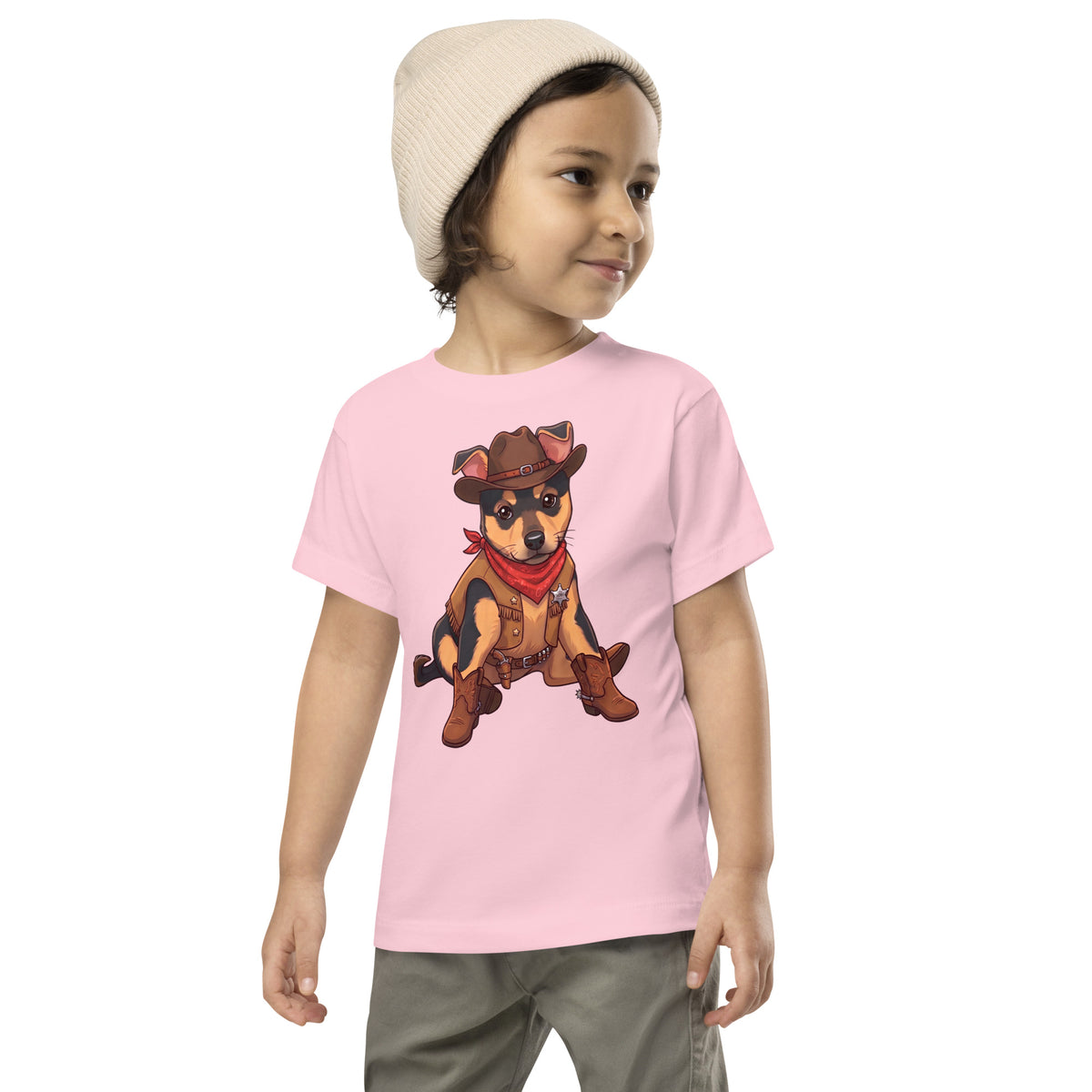 Child in a beige beanie wearing a pink 'howdy pup' toddler t-shirt, dog in a cowboy hat and red bandana, cozy bluesky