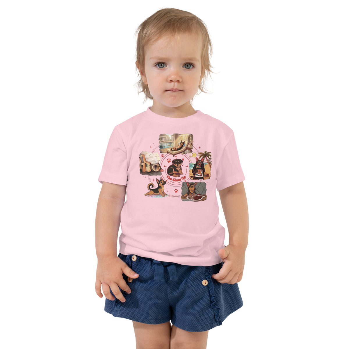 Toddler girl in navy shorts wearing a pink 'glow up' toddler t-shirt, small dog living the good life, cozy bluesky